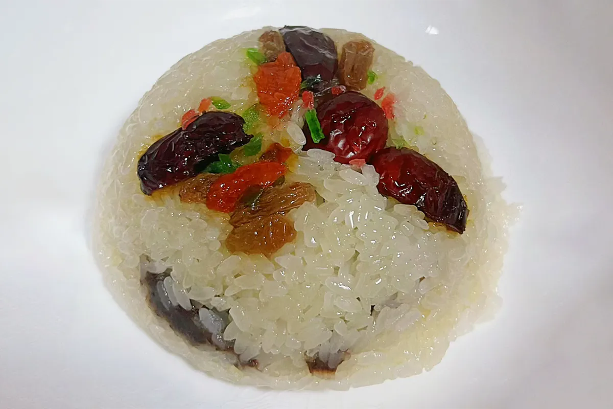 Sticky rice steamed with a colorful mix of nuts, dried fruits, and sweet bean paste, creating a fragrant and comforting traditional dessert at Dim Sum Taste，a Chinese Restaurant in West Chester